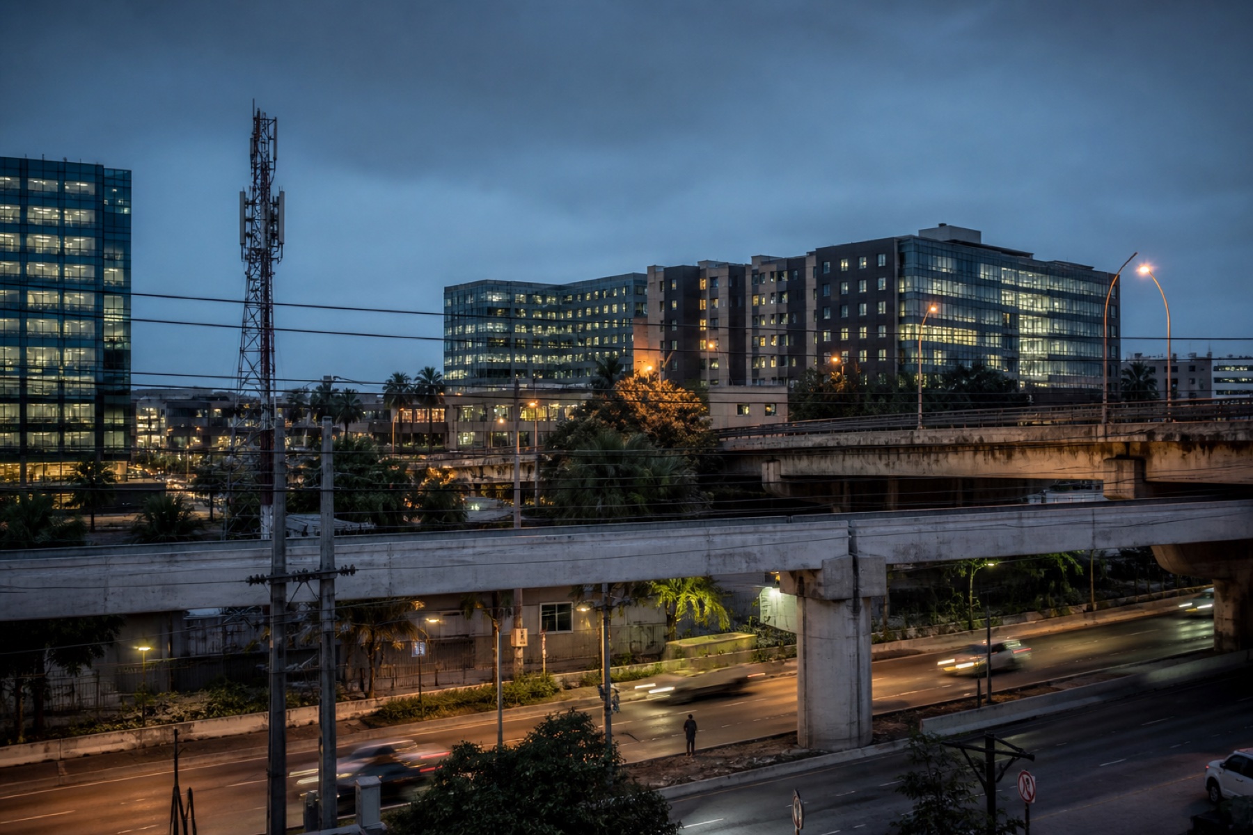 Urban roads, communications infrastructure and offices at blue hour