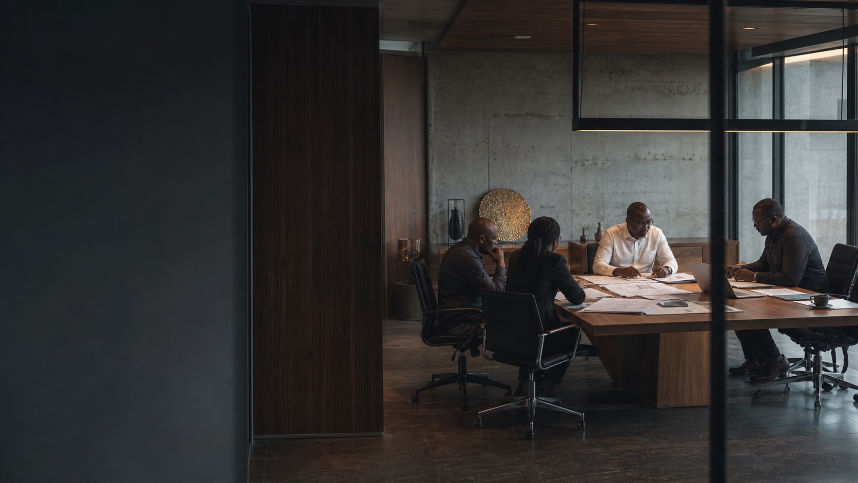 Senior African executives working through plans in a contemporary boardroom